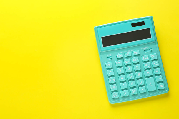 Modern calculator on yellow background, top view. Space for text - Foto, immagini