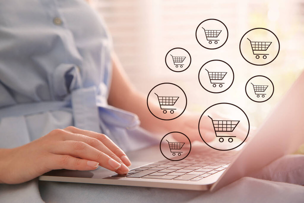 Woman using laptop for online shopping at home, closeup - Fotografie, Obrázek