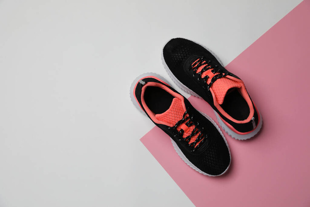Pair of stylish sport shoes on color background, flat lay. Space for text - 写真・画像
