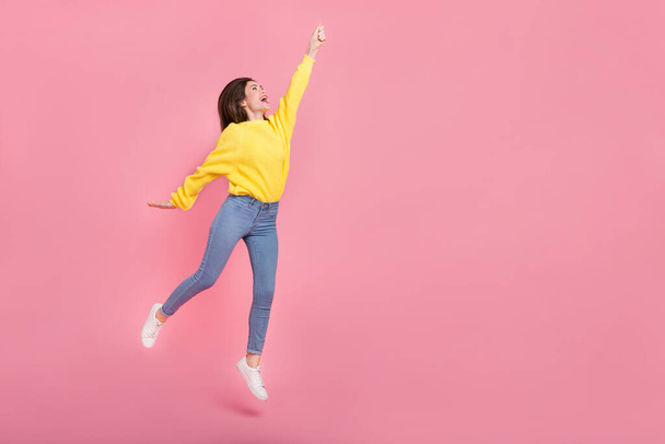 Full size photo of young pretty woman jumper try to catch parasol isolated over pink color background. - Fotoğraf, Görsel