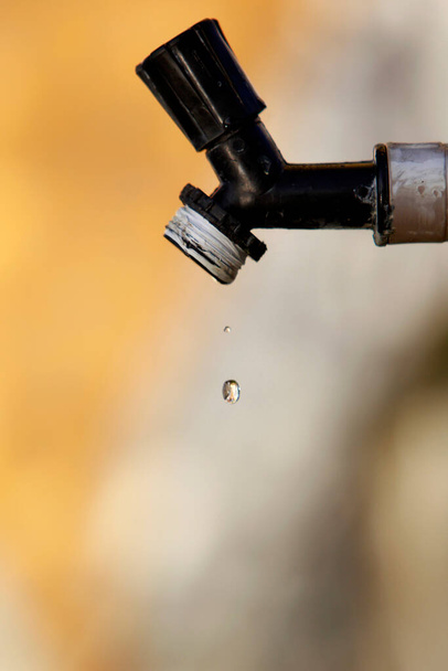 itajuipe, bahia, brazil - june 1, 2022: dripping garden faucet symbolizing lack of water. - Photo, Image