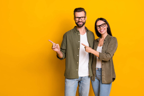 Photo of nice young brunette people index promo wear glasses shirt isolated on yellow color background. - Foto, Imagen
