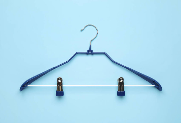 Empty hanger on light blue background, top view - Foto, immagini