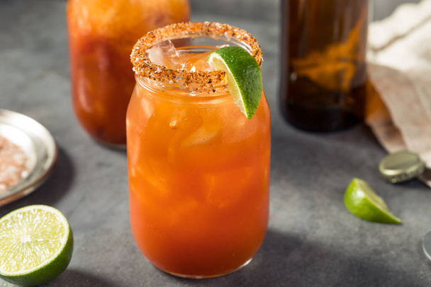 Cold Boozy Tomato Michelada Cocktail with Beer and Lime - Photo, Image