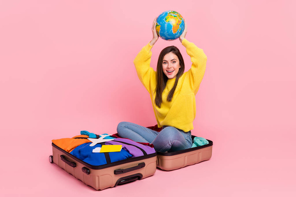 Full size photo of young excited girl prepare trip low-cost air weekend isolated over pink color background. - Фото, зображення