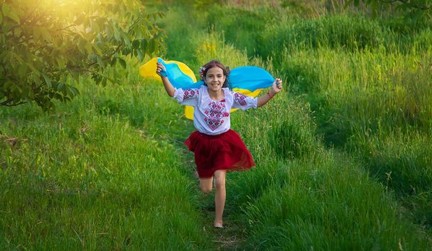 Child with Ukrainian flag patriot stop war. Selective focus. Kid. - Photo, Image