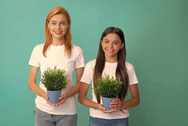 Grow your dreams. Happy woman and girl hold pot plants. Growing houseplants. Home gardening. Grow with care. - Photo, Image
