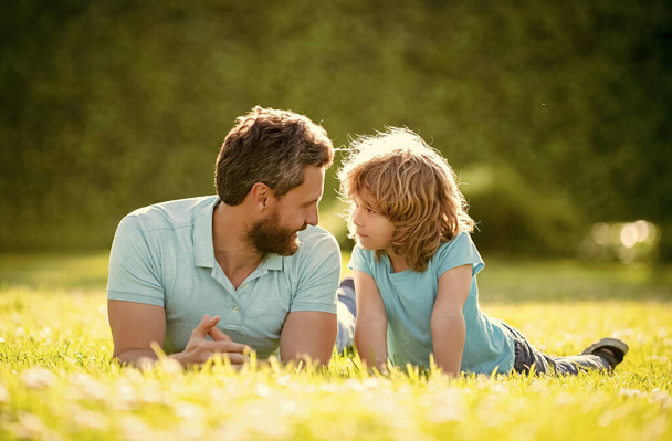 family value. childhood and parenthood. parent relax with little child boy on grass. dad with kid on summer day. parenting and fatherhood. fathers day. loving father and son having fun in park. - Photo, Image