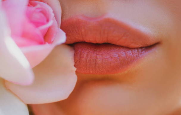 Lips Beauty Closeup. Beautiful woman mouth lips with rose - Фото, изображение