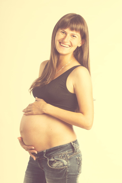 Pregnant woman holding her belly - 写真・画像
