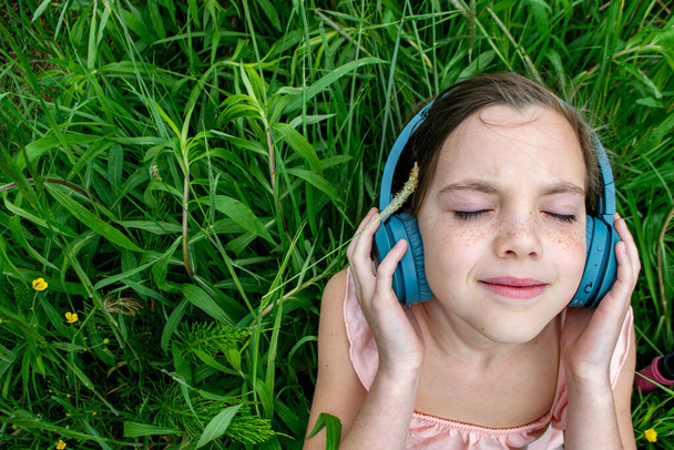 jeune fille écoutant de la musique sur écouteurs. vue de dessus. Le concept de style de vie. Photo de haute qualité - Photo, image