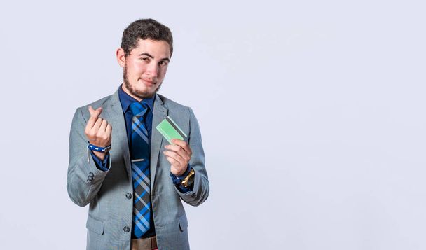 Business man holding credit card isolated, man dressed in suit with credit card smiling, concept of man holding credit card - Photo, Image
