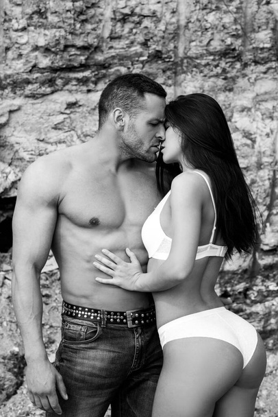 Sexy couple in love. Sensual boyfriend embraces lovers. The concept of tenderness and affection - Фото, зображення