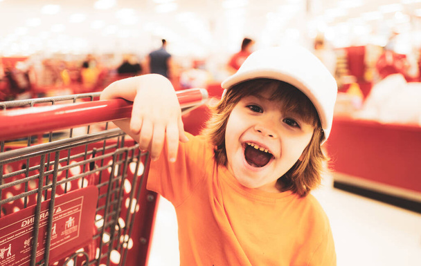 Toddler boy with shopping bag in supermarket - Photo, Image