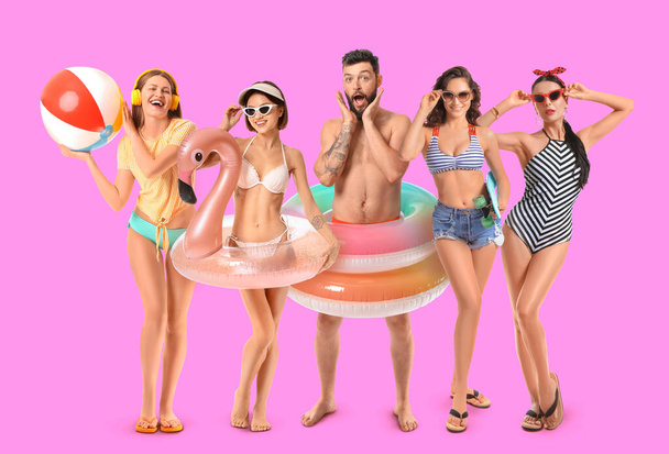 Set of happy young people with inflatable rings on lilac background - Foto, afbeelding