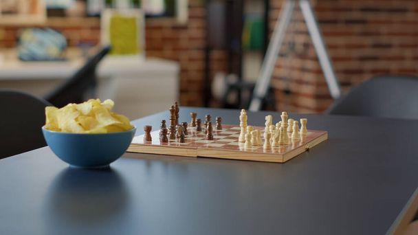 Nobody in living room flat to enjoy modern board games, serving chips and drinking beer to have fun. No people in empty apartment with challenge play for friends to meet, leisure activity. - Fotó, kép