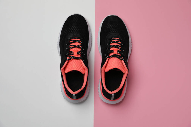 Pair of stylish sport shoes on color background, flat lay - Valokuva, kuva