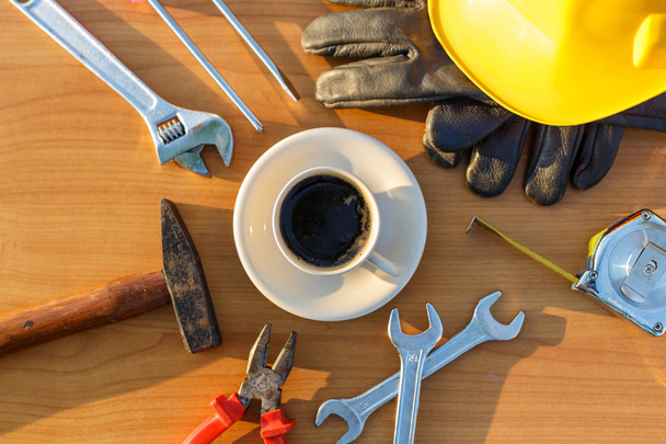 Close up coffee cup and assorted work tools on table - Zdjęcie, obraz