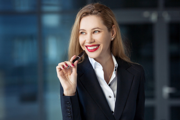 portrait of a business woman with a pen on the background of the - Photo, image