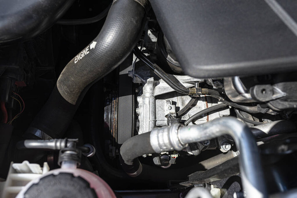 Air conditioning compressor in passenger car with diesel engine, located in the engine compartment. - Photo, Image