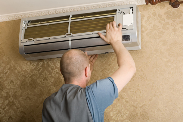 Technician installs a new air conditioner in the apartment - Fotó, kép