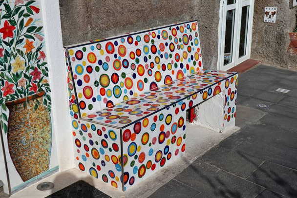 Sant'Angelo d'Ischia, Campania, Italy - May 13, 2022: Multicolored ceramic bench in the alleys of the village - Photo, Image