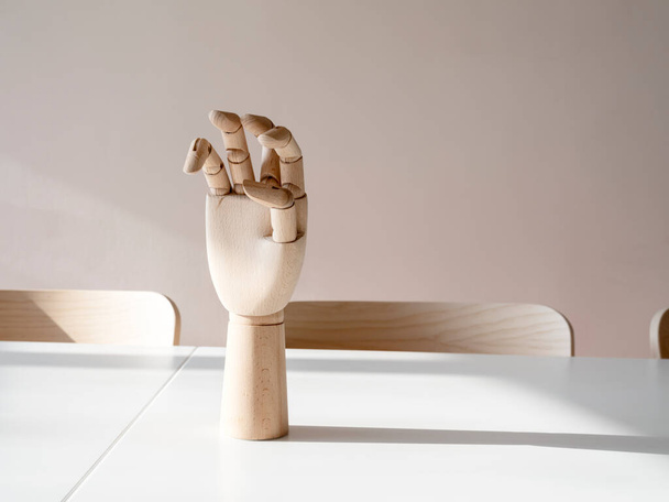 wooden hand on office desk, front view - Photo, Image