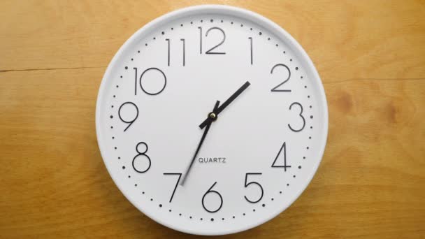 Wall clock on wooden wall. Clock hands running fast. Seamless loop - Footage, Video
