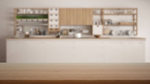 Mesa de madera vacía, escritorio o estante con vista borrosa de la cocina blanca moderna con gabinetes y estantes, decoraciones y accesorios, concepto de diseño interior moderno - Foto, Imagen