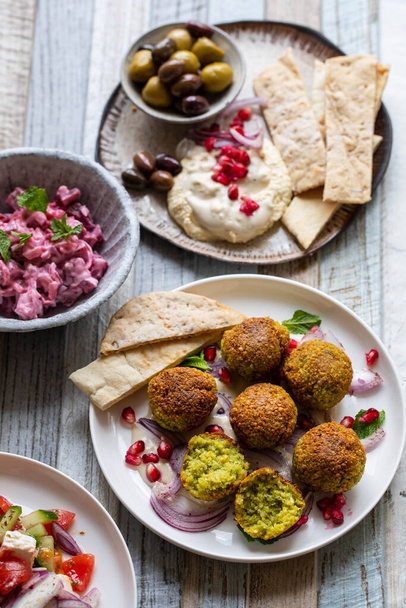 Middle eastern spread with falafel, olives and beetroot salad - Photo, Image