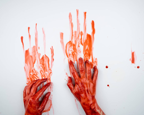 Female hands in blood on a white background - Foto, Imagem