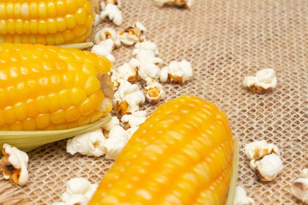 Brazilian party snacks with corn and popcorn on straw background - Photo, Image