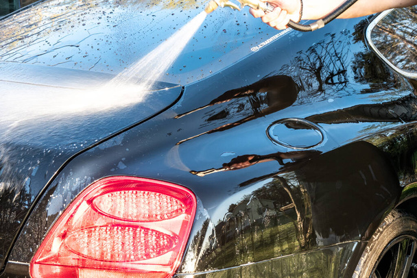 auto detailer washing luxury high end car - Photo, Image