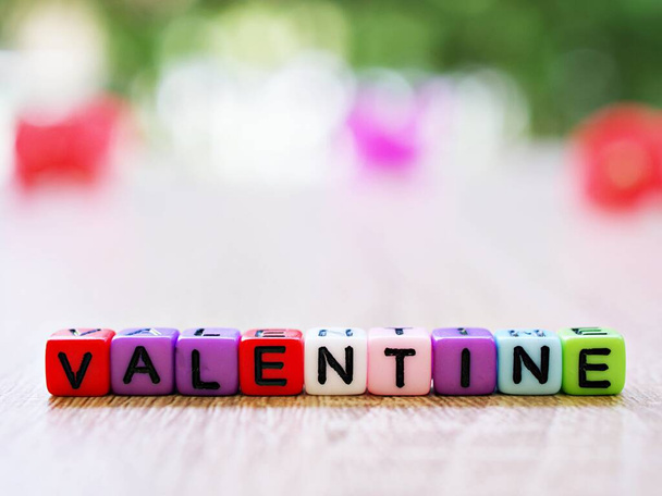 Alphabet 'valentine' beads in cube shape with blurred background ,block letters ,happy holiday wallpaper or text ,colorful characters design ,capital square ,alphabetical artistic ,pastel colored  - Fotó, kép