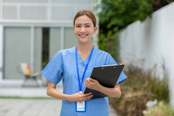 Asian female doctor with a stethoscope smile looking at camera.Nurses wear scrub smile with heartwarming comfortable.Positive emotional and good moment.Health Care Concept - Foto, Imagen