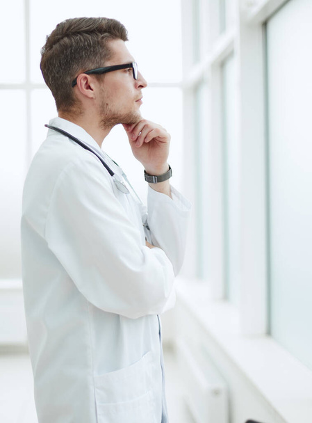 Portrait of young, doctor sitting in medical office - Foto, immagini