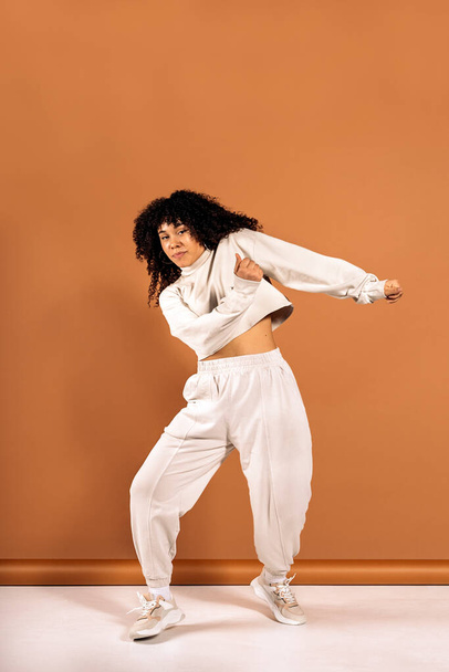 Stock photo of beautiful african woman with curly hair dancing in studio shot. - Fotó, kép