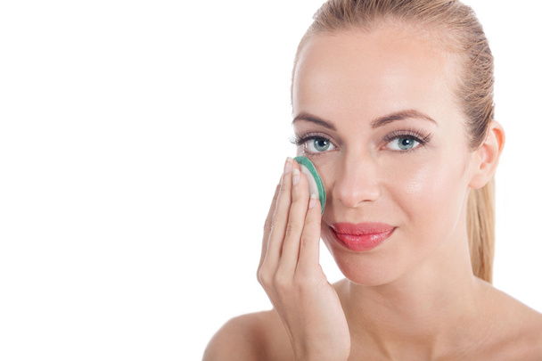  woman removing face make-up with cotton swab pad - Fotó, kép