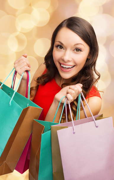 smiling woman with colorful shopping bags - Foto, afbeelding