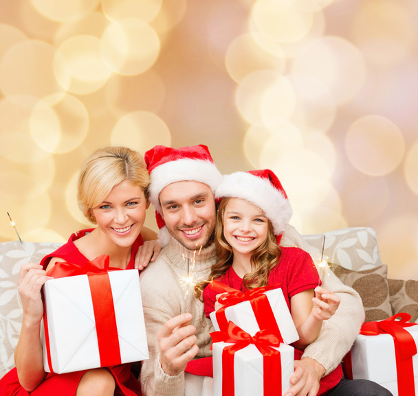 happy family in santa helper hats with gift boxes - Zdjęcie, obraz