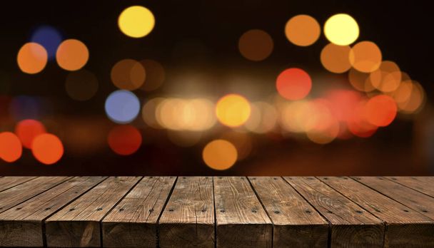 Empty old wooden table with bokeh lights in background - Photo, Image