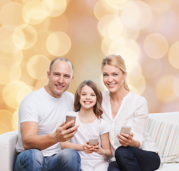 happy family with smartphones - Foto, afbeelding