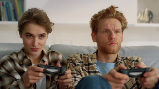 Gamers holding joystick home having fun closeup. Players enjoying video game. Smiling ginger man getting victory in online virtual battle at home. Excited family resting holding controllers in hands. - Footage, Video