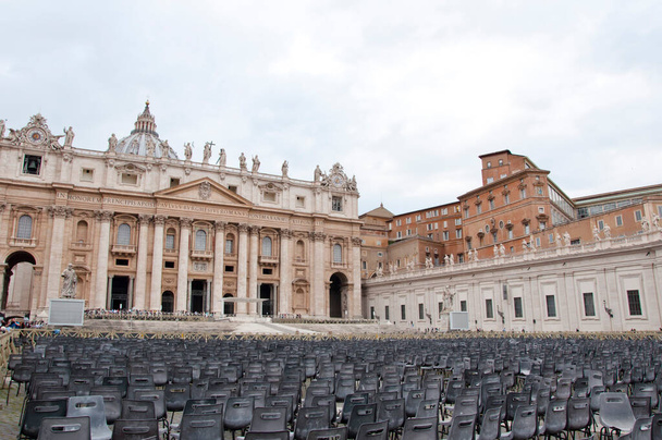 Empty chairs on Saint Peters Square infront Saint Peters Basilica in Vatican City in Rome, Italy. - Photo, Image
