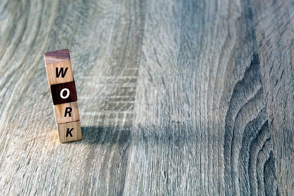 Wooden block cube with text "WORK" on wood table. Backgrounds, bussines, work, job concept - Foto, afbeelding