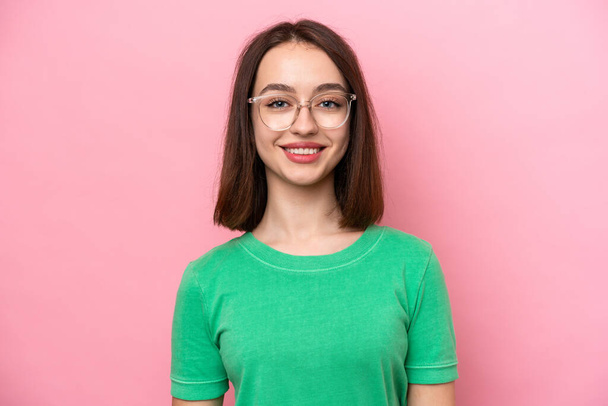 Young Ukrainian woman isolated on pink background With glasses with happy expression - Foto, Imagen