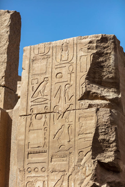 Different hieroglyphs on the walls and columns in the Karnak temple. Karnak temple is the largest complex in ancient Egypt. - Photo, Image
