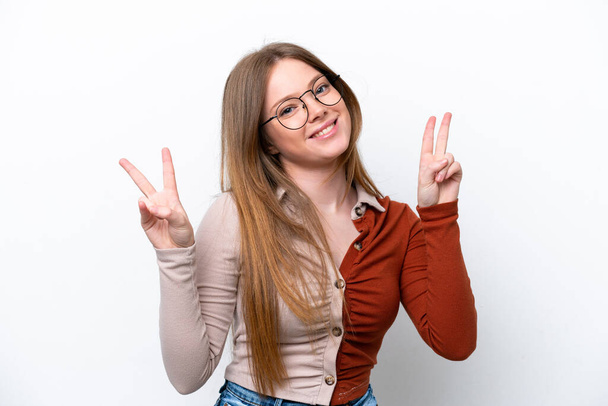 Young caucasian woman isolated on white background showing victory sign with both hands - Foto, immagini