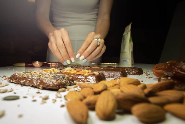 different nuts surround an energy bar of which are its ingredients - Photo, Image