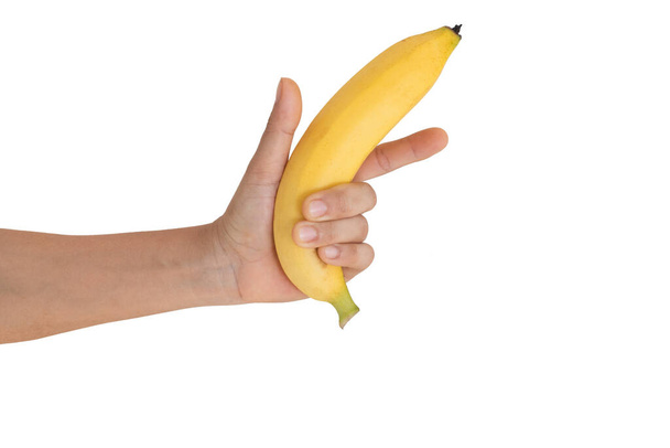 Рука тримає банан. Ізольовані на білому тлі
. - Фото, зображення
